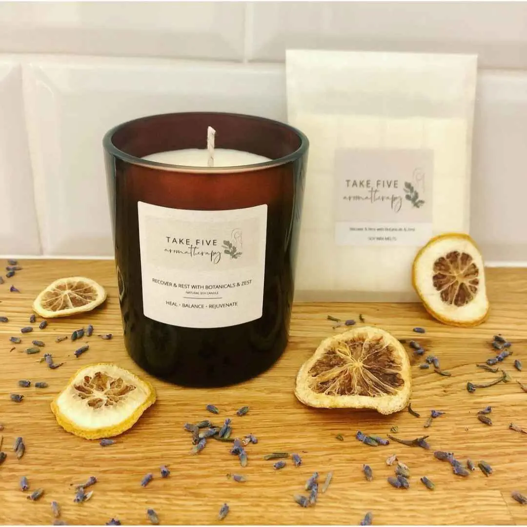 Single wick candle in a dark brown glass jar