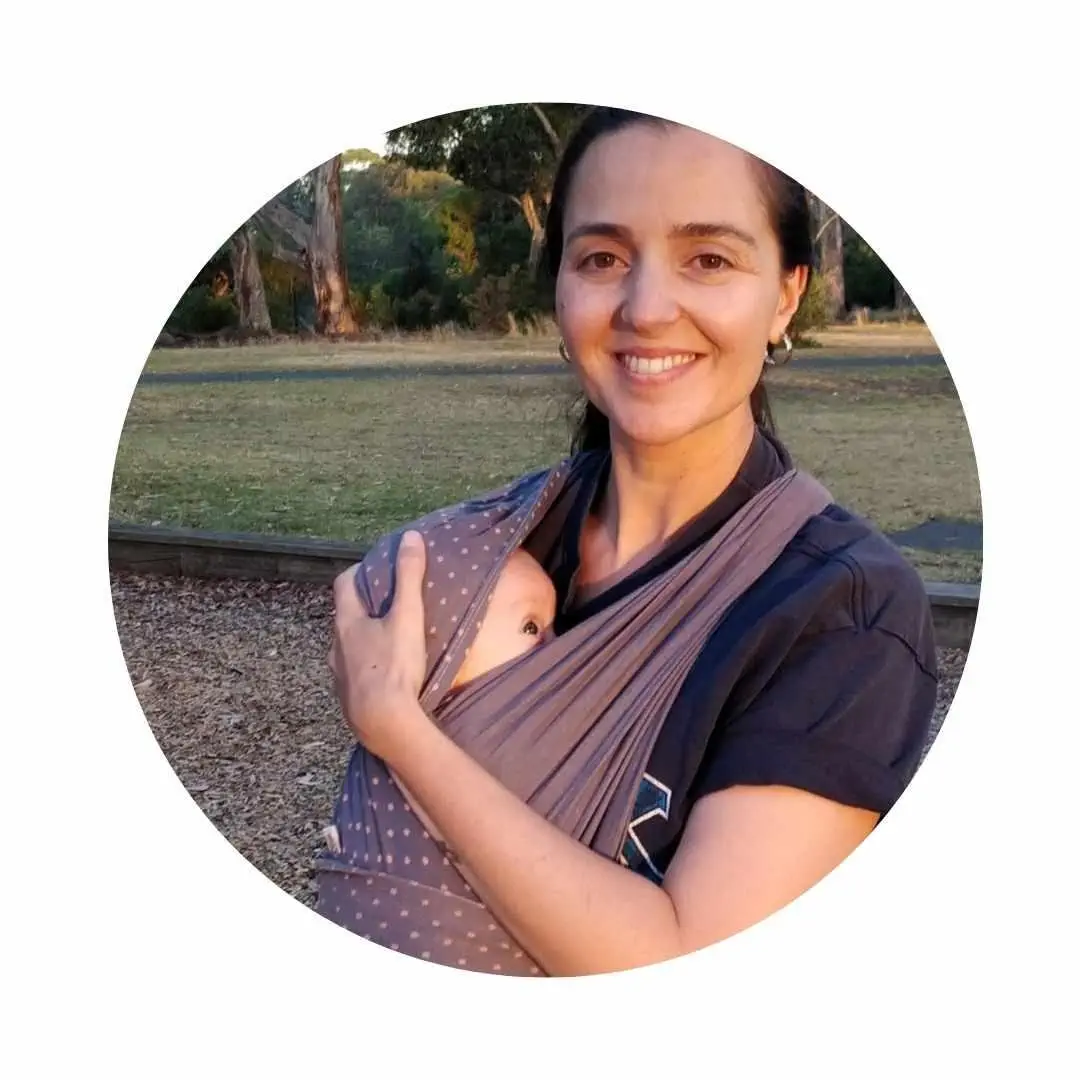 Portrait photo of registered nurse Julia Quinn with baby in a sling